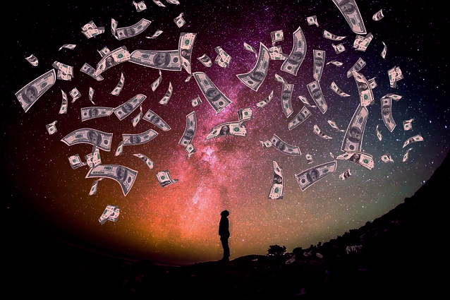 Money raining down on a silhouette of a man looking up.  Galaxy background.